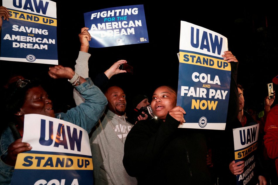 United Auto Workers members hold up strike signs across from the Ford Michigan Assembly Plant in Wayne, Michigan.