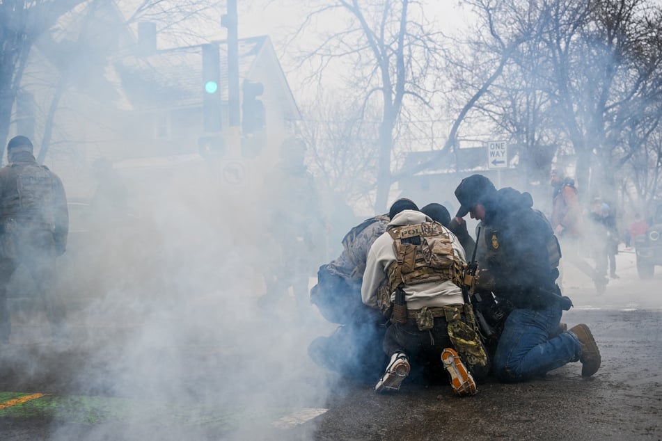 A person is detained by US Border Patrol agents during at an intersection in Minneapolis, Minnesota, on January 21, 2026.