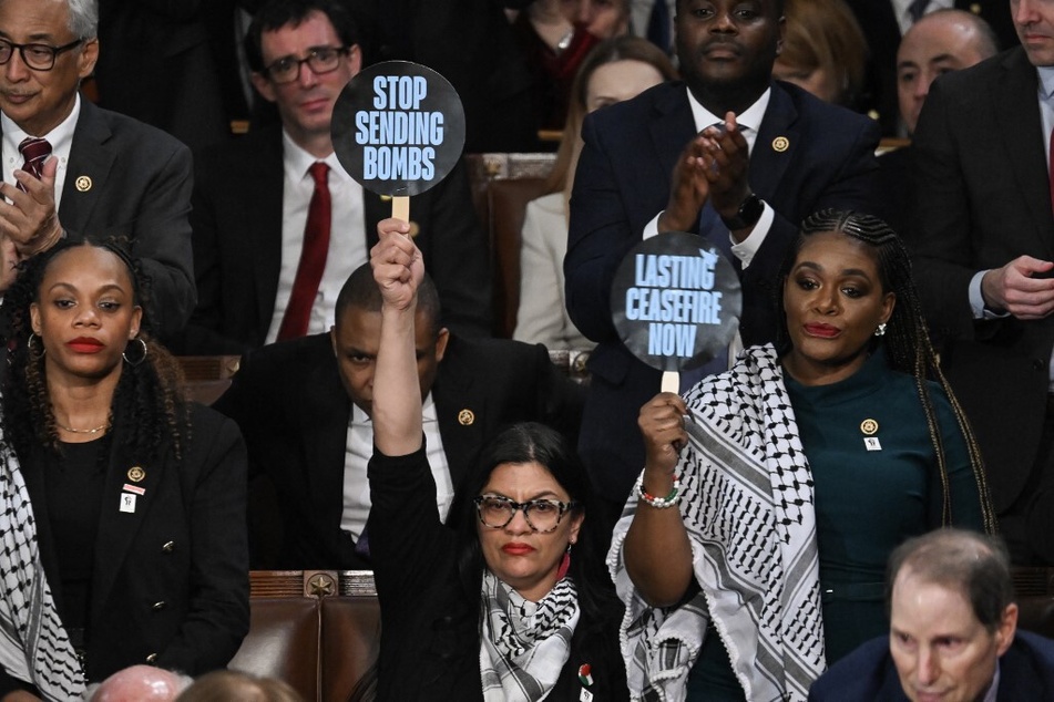 From l. to r.: Congresswomen Summer Lee, Rashida Tlaib, and Cori Bush – targets in the Israel lobby's campaign to oust progressives – wear Palestinian keffiyehs and raise signs during President Joe Biden's 2024 State of the Union speech.