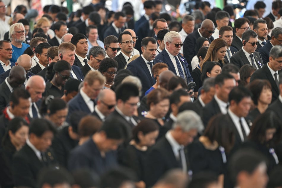 US Ambassador to Japan George Glass (top centre R - white hair and sunglasses) and other diplomats attend the annual memorial ceremony at the Hiroshima Peace Memorial Park in Hiroshima on Wednesday, to mark 80 years since the world's first atomic bomb attack.
