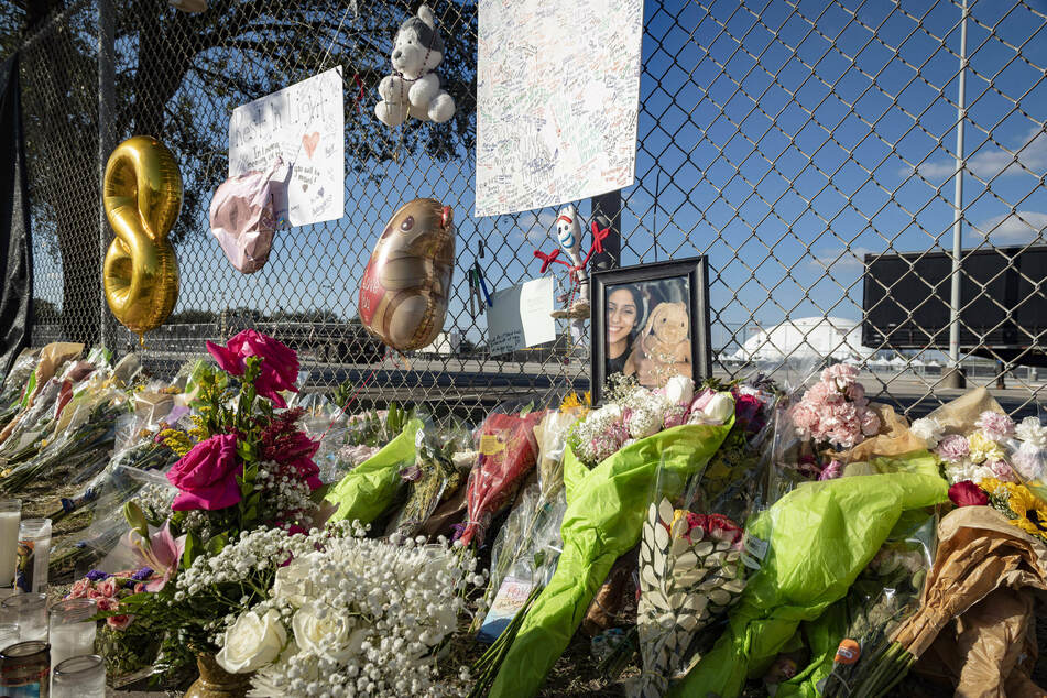 Candles, flowers, and letters are placed at a memorial outside the Houston venue where the Astroworld disaster took place.