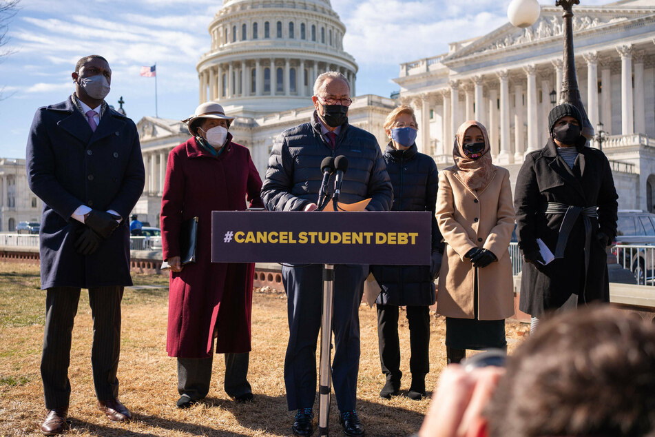 Senate Majority Leader Chuck Schumer (c.) speaking at a press conference along with (l. to r.): Rep. Mondaire Jones, Rep. Alma Adams, Sen. Elizabeth Warren, Rep. Ilhan Omar, and Rep. Ayanna Pressley.