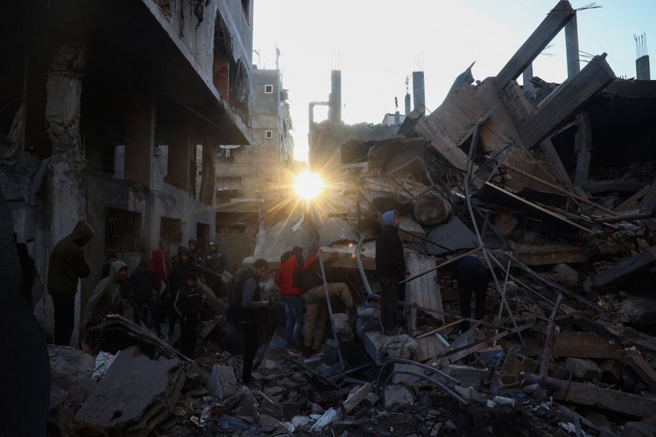 People search the rubble of a building destroyed in an Israeli strike on the Bureij camp for Palestinian refugees in the central Gaza Strip on January 8, 2025.