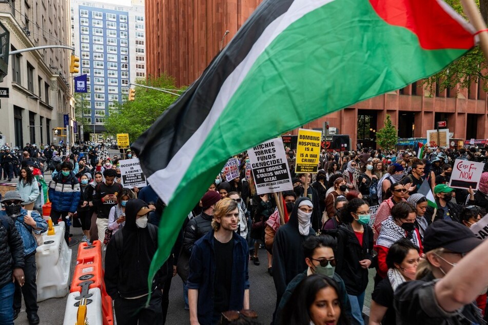 Protesters for Palestinian freedom gather outside of New York University buildings in lower Manhattan to rally against their school's investments and support for Israel.