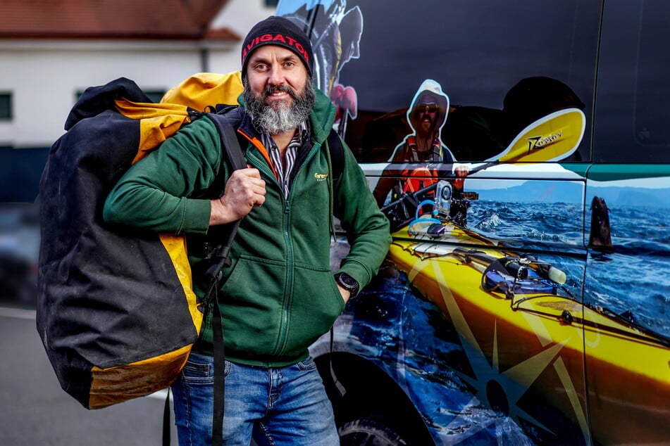 Gil Bretschneider (47) steht mit gepackten Rucksäcken am Expeditions-Auto.