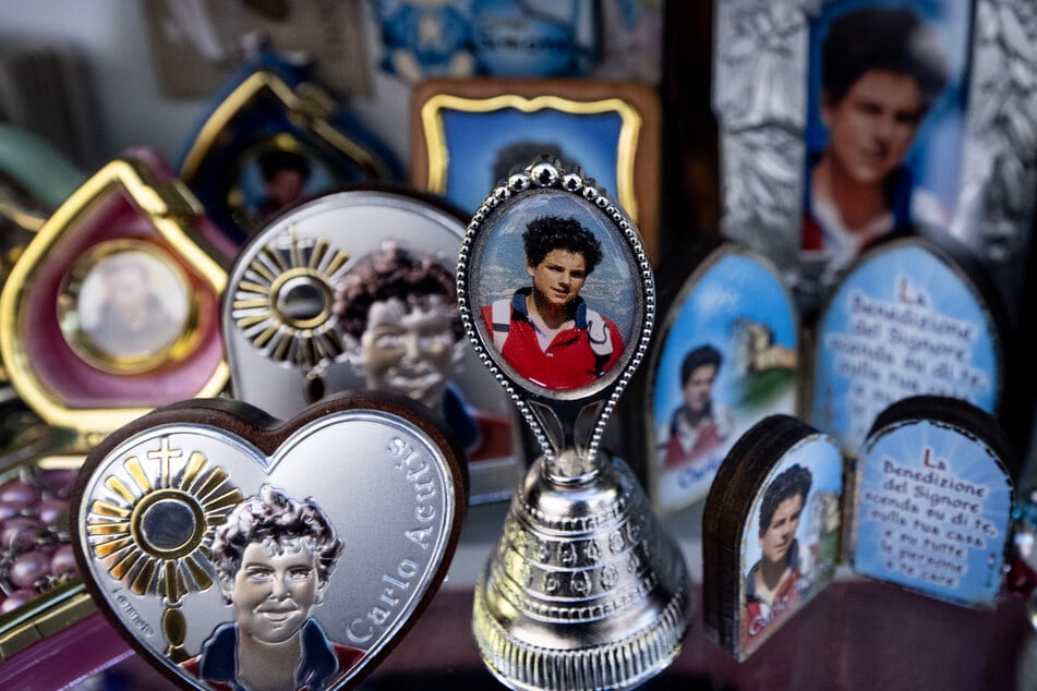 Pictures of Blessed Carlo Acutis, an adolescent who spent his life spreading his faith online, are printed on souvenirs in a shop of Assisi where Acutis is on display.