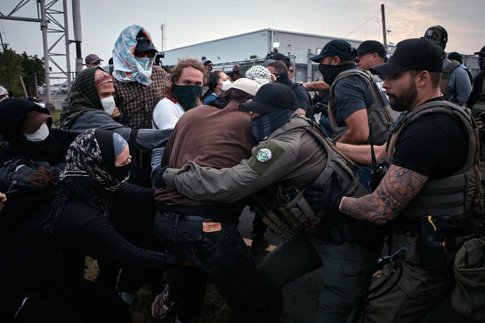 Federal agents grab and push protestors during a demonstration against federal immigration raids at Delaney Hall in Newark, New Jersey, on June 13, 2025.