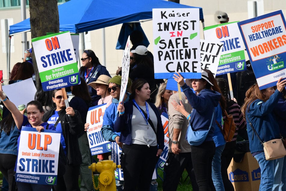 Nurses and health care professionals demonstrate during a strike against Kaiser Permanente outside one of their medical facilities in Los Angeles, California, on January 26, 2026.