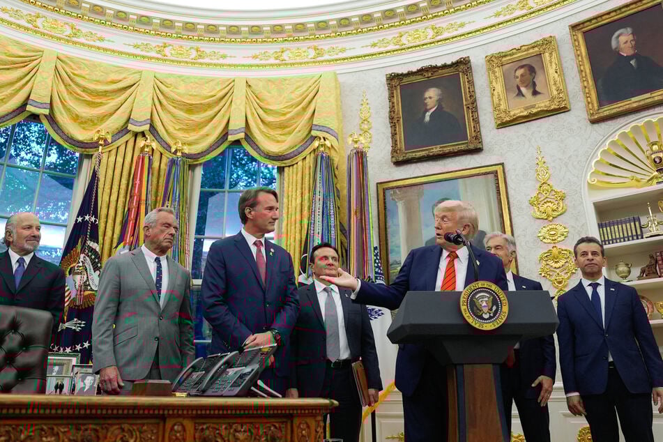 President Donald Trump was joined by AstraZeneca CEO Pascal Soriot (3rd from l.) as he announced an agreement that could lead to lower drug prices.