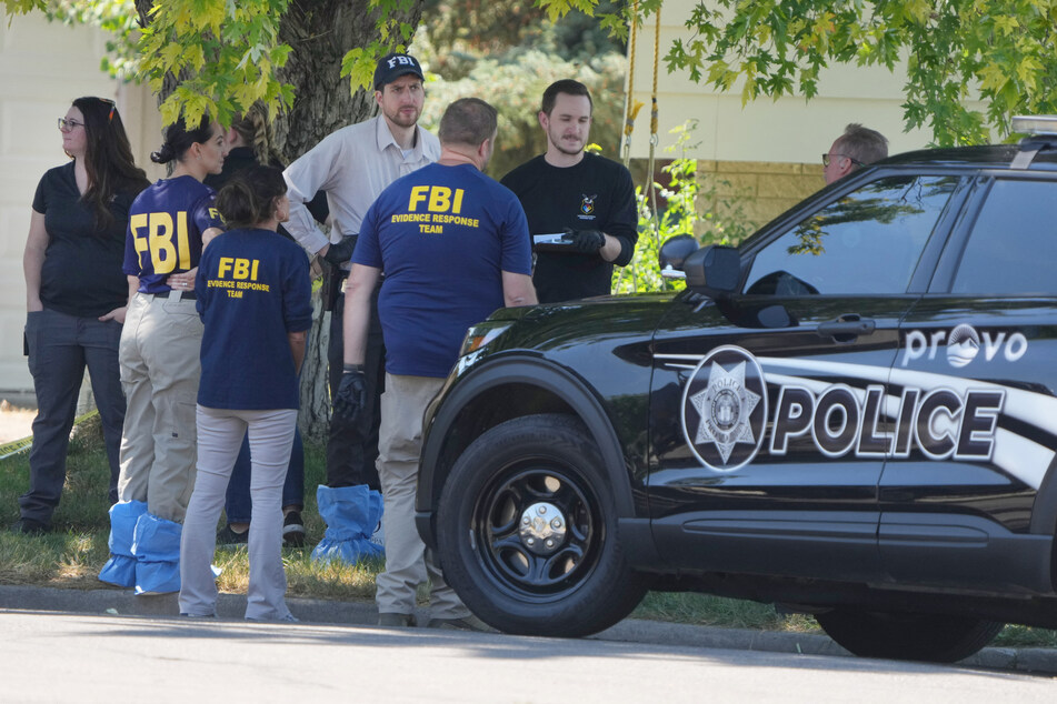 FBI officials outside the home of Craig Robertson, who was shot and killed in a raid on his home in Provo, Utah after his alleged threats to President Biden.