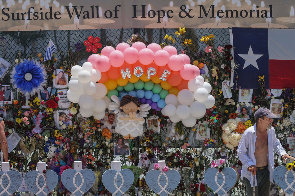 Wooden hearts with the names of victims were erected alongside the photos, flowers, and other memorial items at Surfside's Wall of Hope.