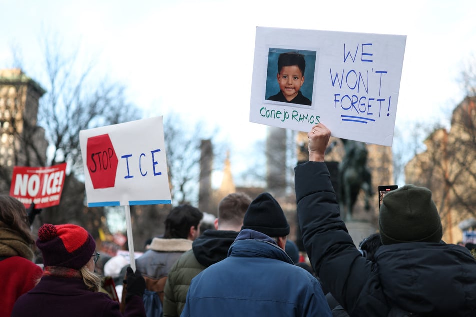 People hold a photo of Liam Conejo Ramos, a five-year-old boy who was detained by US immigration officers in Minneapolis, during an "ICE Out" protest in New York on January 23, 2026.