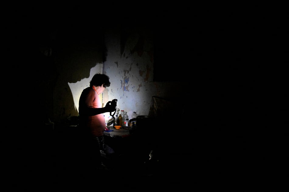 A man in Havana uses a flashlight during a blackout as Cuba's national electric grid collapsed on March 16, 2026.