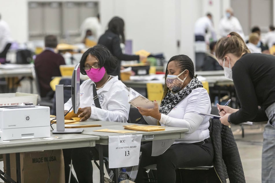 Workers for the Detroit Department of Elections count absentee ballots and early voting ballots in the 2020 presidential election.