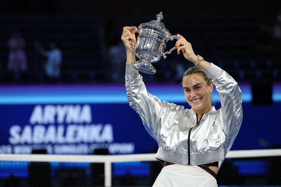 Aryna Sabalenka celebrates with the trophy after winning the women's singles final at the 2025 US Open.
