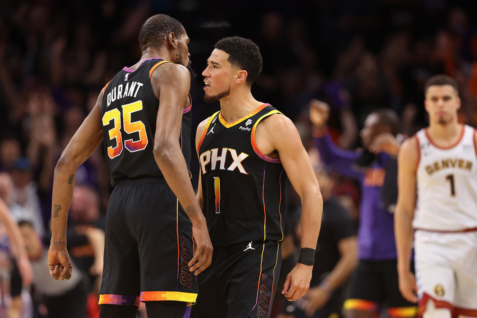 Phoenix Suns stars Kevin Durant and Devin Booker combined for 86 points in a 121-114 win over the Denver Nuggets.