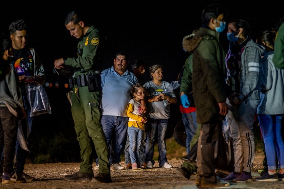 A migrant family waits to be processed in Roma, Texas, after crossing the Southern border.