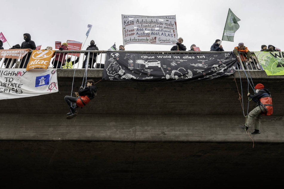Aktivisten des Bündnisses "Wald statt Asphalt" haben sich am heutigen Samstag von einer Brücke über die Autobahn 648 abgeseilt.
