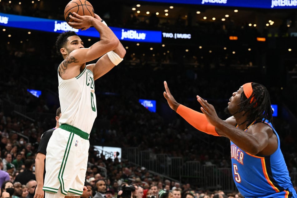 Boston Celtics forward Jayson Tatum attempts a three-point basket in front of Oklahoma City Thunder forward Luguentz Dort during the first half at the TD Garden.