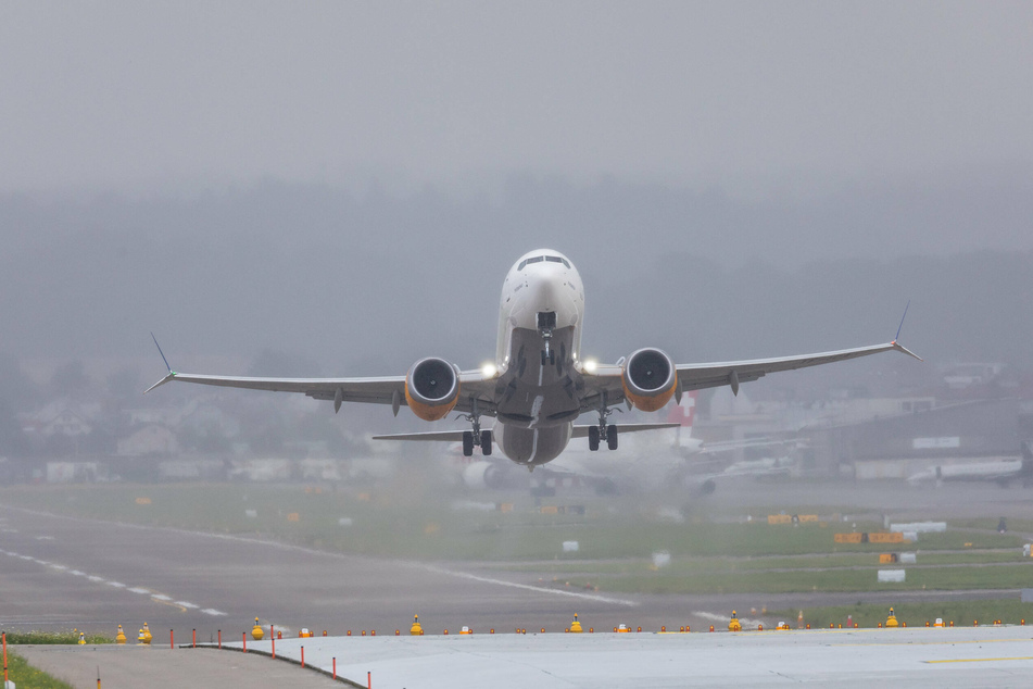 A Boeing 737 Max plane takes off from the runway.