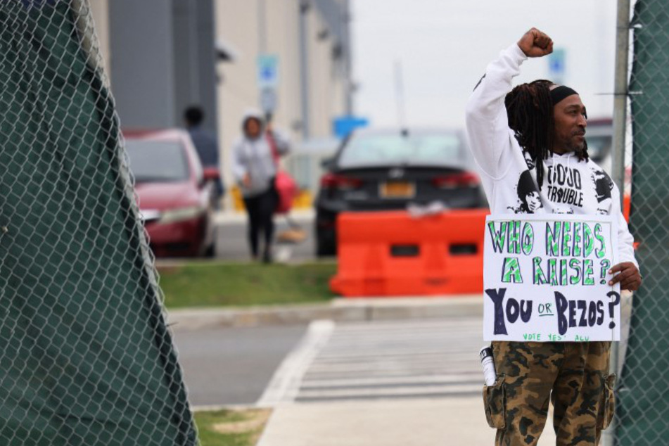 An Amazon Labor Union organizer holds a sign before the vote at the LDJ5 facility in Staten Island.