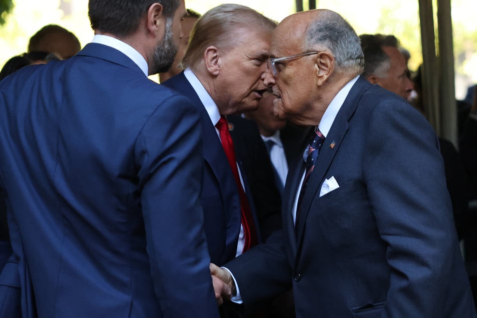 President Donald Trump (c.) announced that he intends to award former New York City Mayor Rudy Giuliani (r.) the Presidential Medal of Freedom.