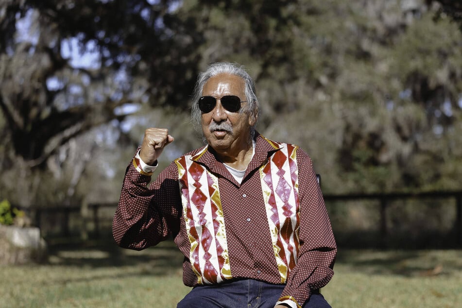 Indigenous freedom fighter Leonard Peltier raises his fist outside the Coleman Federal Correctional Complex after his release from prison.