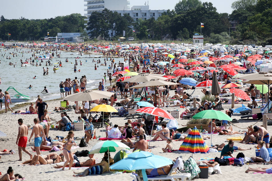 Badegäste brutzeln am Timmendorfer Strand an der Ostsee in der Sonne. In den kommenden Tagen dreht der Sommer richtig auf. (Archivbild)