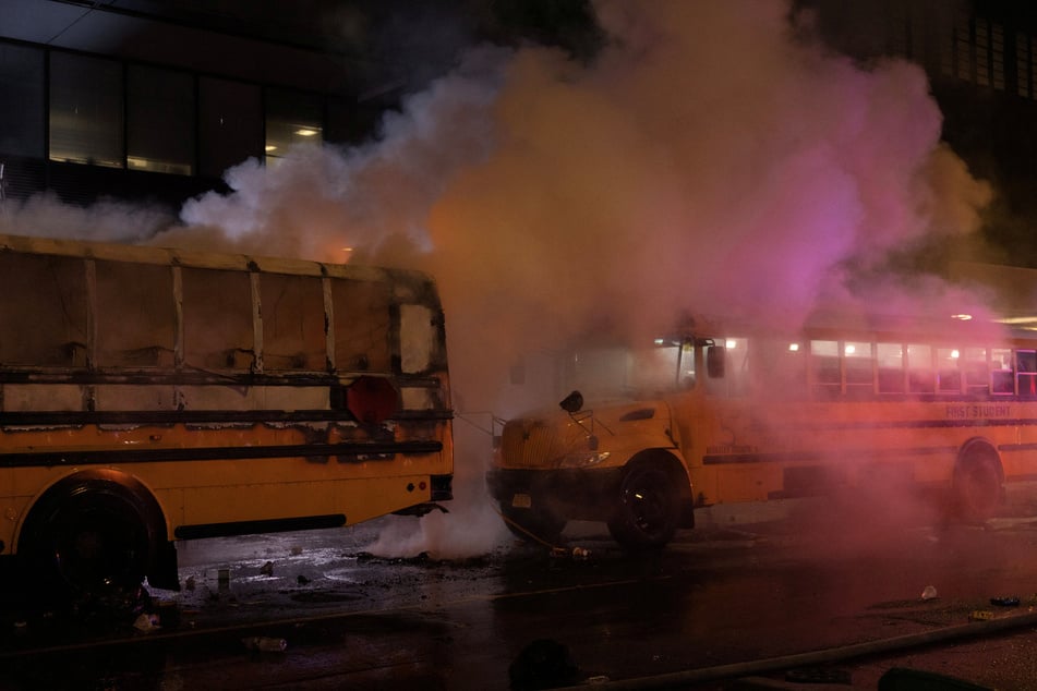 A fire on a shuttle bus, used to transport spectators for 2026 FIFA World Cup, is extinguished outside the Port Authority Bus Terminal in New York amid celebrations over the Knicks' NBA championship win on June 14, 2026.
