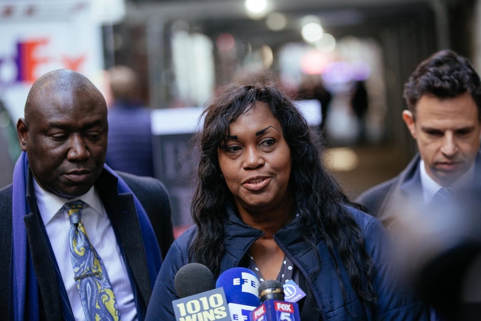 Tamara Lanier (c.) speaks alongside attorney Ben Crump (l.) during a press conference announcing a lawsuit against Harvard University on March 20, 2019, in New York City.
