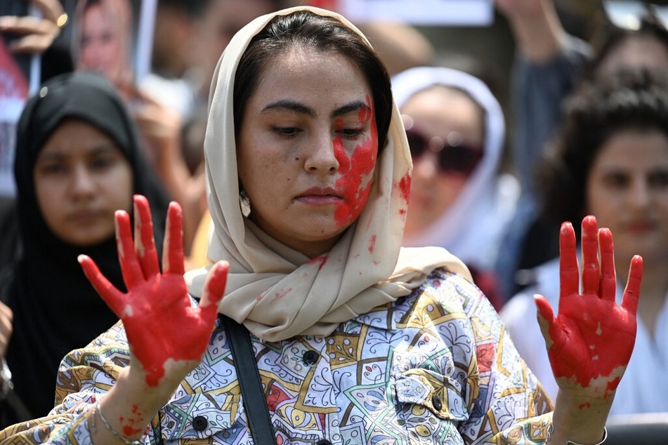 An Afghan national with her hands and face painted demonstrates against the Taliban government in Islamabad, Pakistan, on August 15, 2023, the second anniversary of the Taliban takeover of Afghanistan.