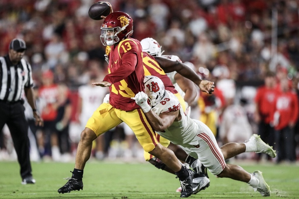 Caleb Williams' (l.) dreams of securing a second Heisman Trophy and guiding USC to the playoffs have been dashed.