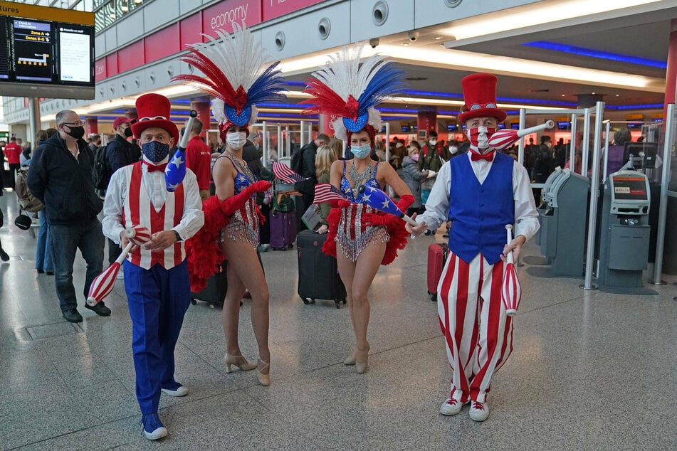 Performers entertain passengers at London Heathrow Airport.