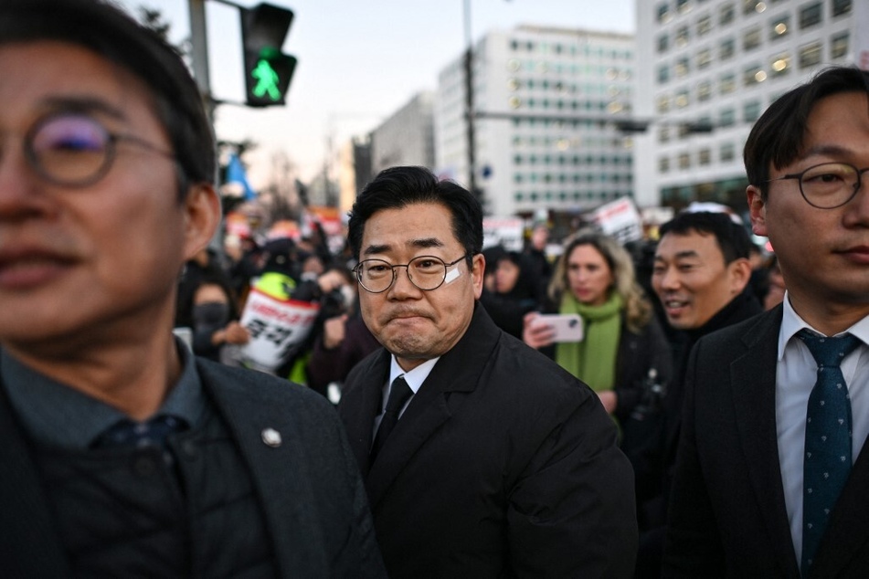 Park Chan-dae (c.), floor leader of the Democratic Party of Korea, gathers with people to take part in a protest calling for the ouster of South Korean President Yoon Suk Yeol outside the National Assembly in Seoul on December 6, 2024.