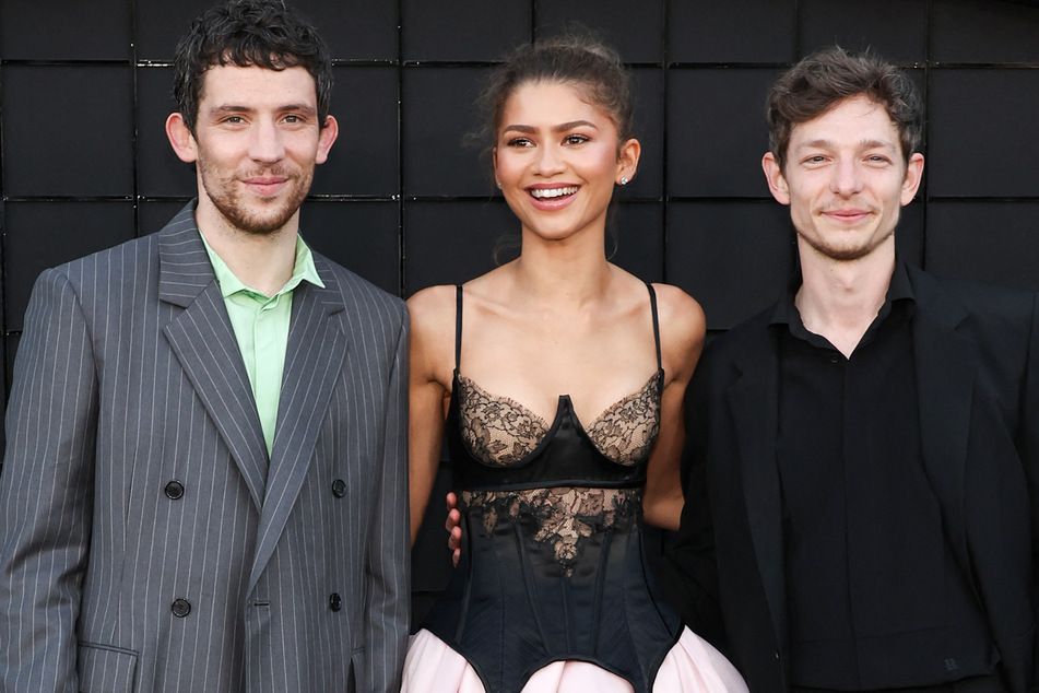 Zendaya (c.) has been repeatedly asked about kissing her Challengers co-stars Josh O'Connor (l.) and Mike Faist throughout the movie's press tour.