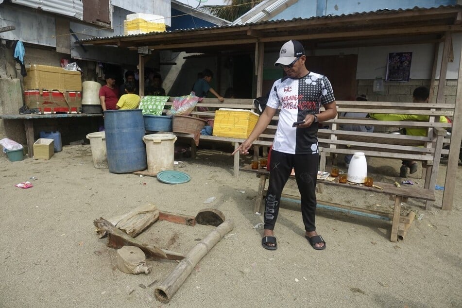 A man points to a believed to be bloodstain in the sand in Sibuco, Zamboanga del Norte on October 18, 2024, where abducted American national Elliot Onil Eastman was shot by gunmen.