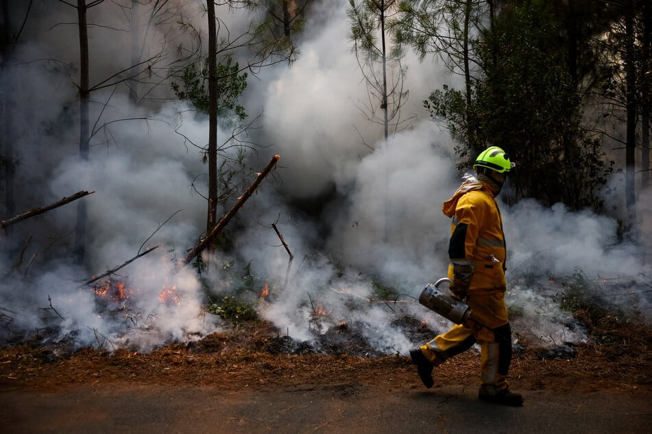 A firefighter takes part in controlled burning operations in Le Porge, Gironde department, amid drought conditions following a heatwave and water shortages across much of France, on July 30, 2026.