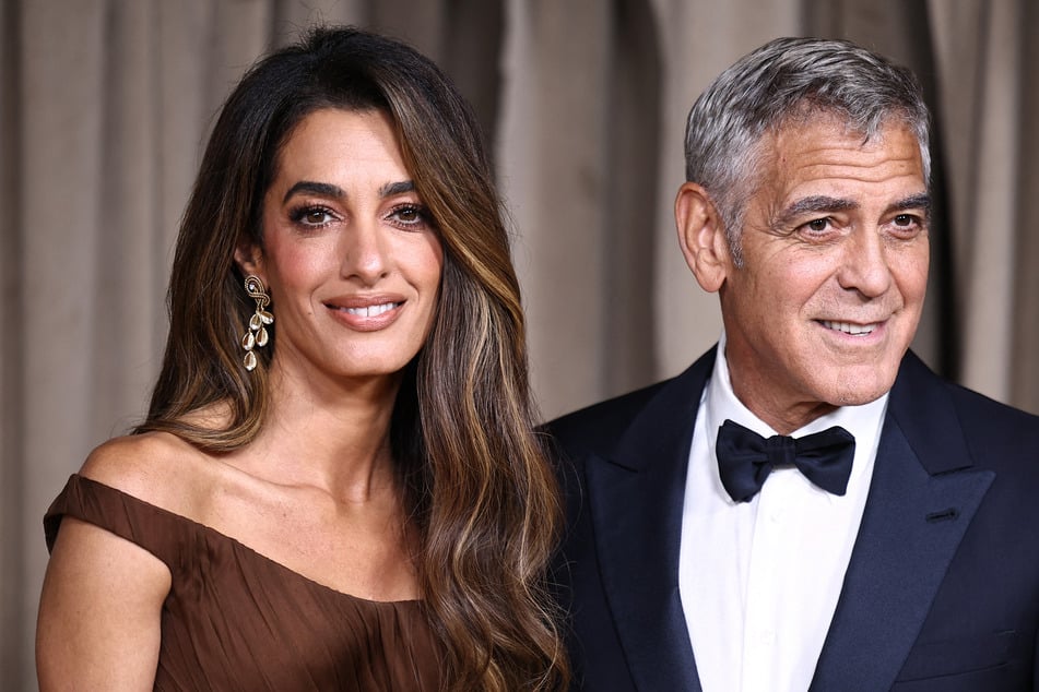 George Clooney (l.) and his wife Amal have earned French citizenship as the Hollywood star seeks to protect his family from the paparazzi.
