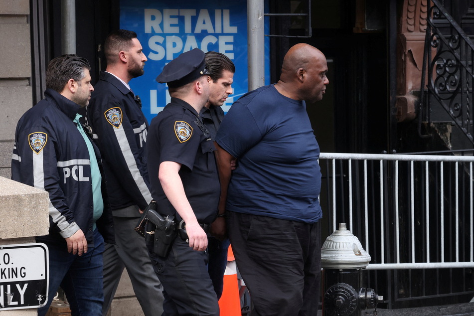 James being led to a police car shortly after his arrest.