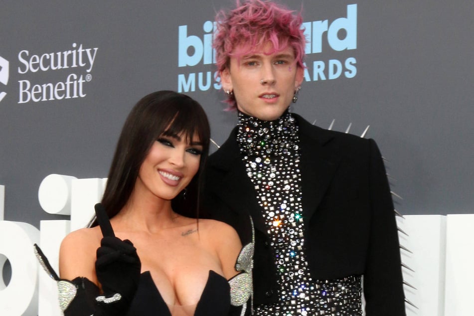 Following Megan Fox (l.) and Machine Gun Kelly's (r.) baby news, insiders have revealed where the twin flames stand in their romance.