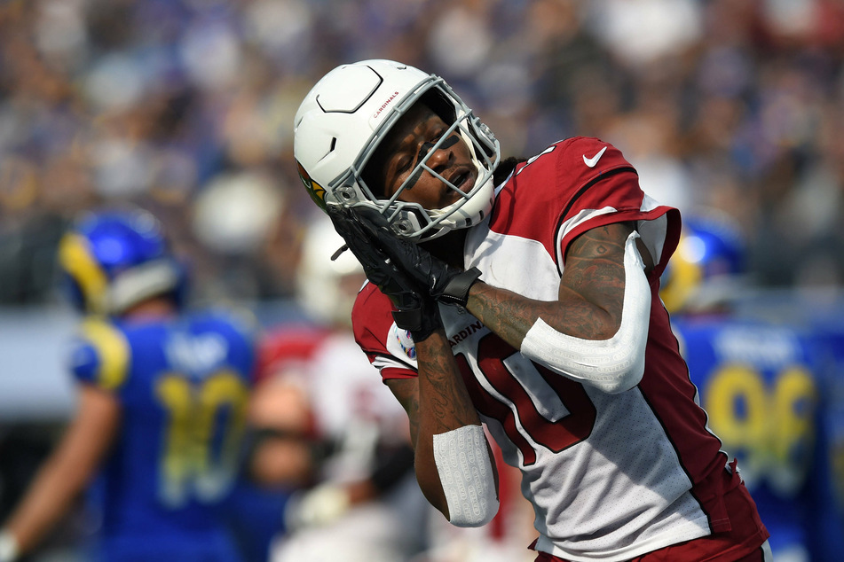 Cardinals wide receiver DeAndre Hopkins (10) celebrates a Cardinals touchdown while mimicking falling asleep.