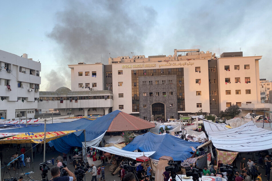 Smoke rises as displaced Palestinians take shelter at Al-Shifa hospital in Gaza City, which has been the repeated target of Israeli attacks.