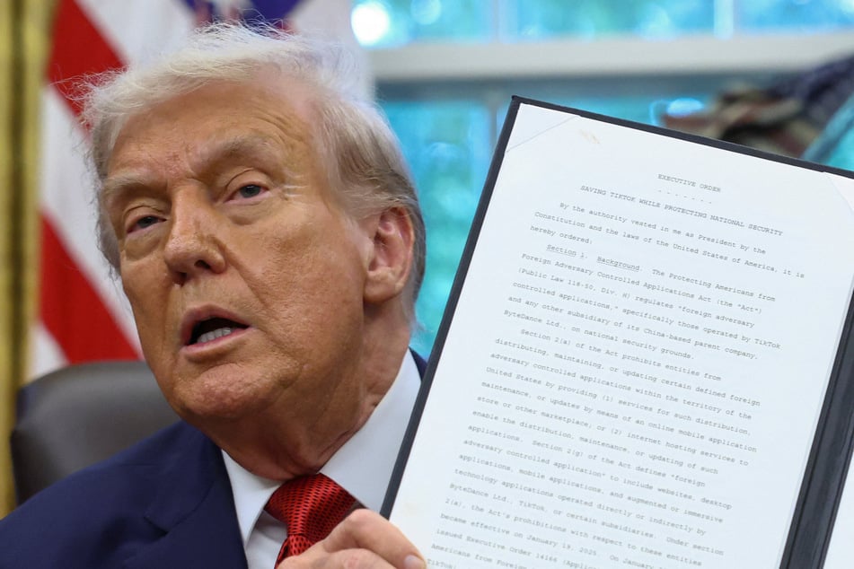 President Donald Trump shows a signed executive order on a deal that would divest TikTok's US operations from its Chinese owner ByteDance on September 25, 2025.