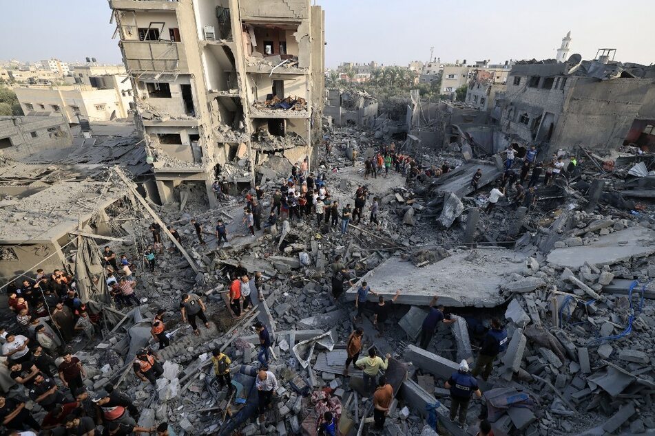 People check the damage caused by an Israeli strike on the Al-Maghazi refugee camp in Deir Balah in the central Gaza Strip on November 5, 2023.