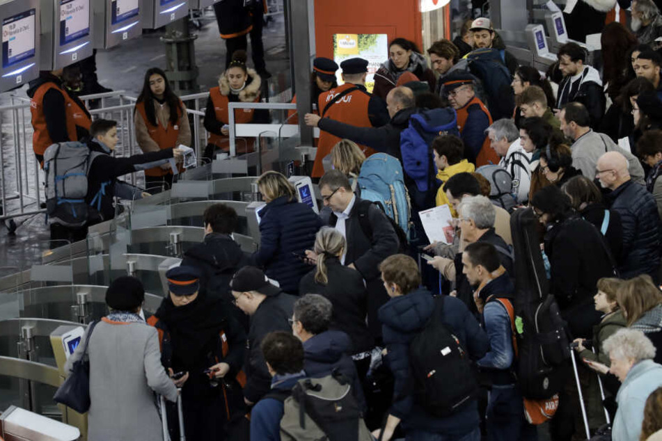 Pendler stehen am Bahnhof "Gare de Lyon" an, um in einen Zug zu steigen. Die Gewerkschaften planen auch für Januar Streiks und Proteste, um sich den Plänen der Regierung zur Anhebung des Rentenalters auf 64 Jahre zu widersetzen.