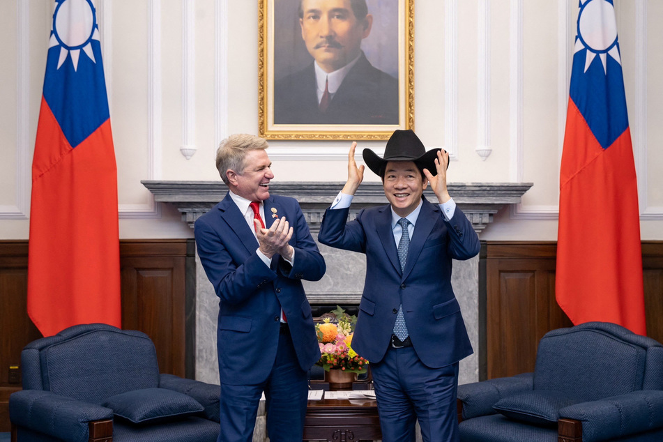 Taiwan's President Lai Ching-te (r.) dons a cowboy head as he meets with Republican Representative Michael McCaul from Texas.