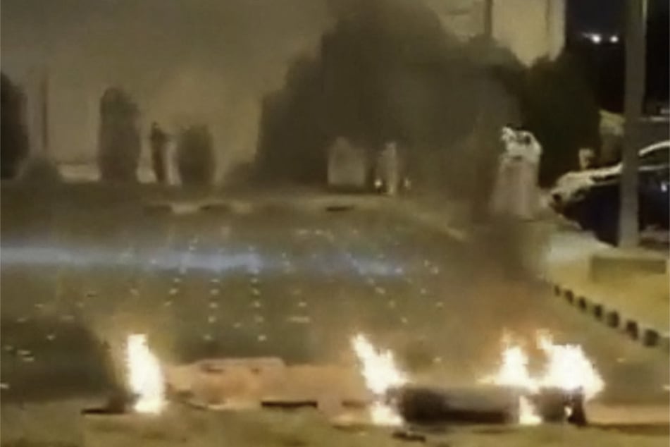 Debris burns on the ground in a parking lot following reports of missile and drone attacks in Sabah Al Nasser, Kuwait, on June 3, 2026.