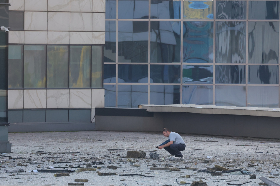 Debris litters the streets in the aftermath of a Ukranian drone attack on an office bloc in Moscow's business district.