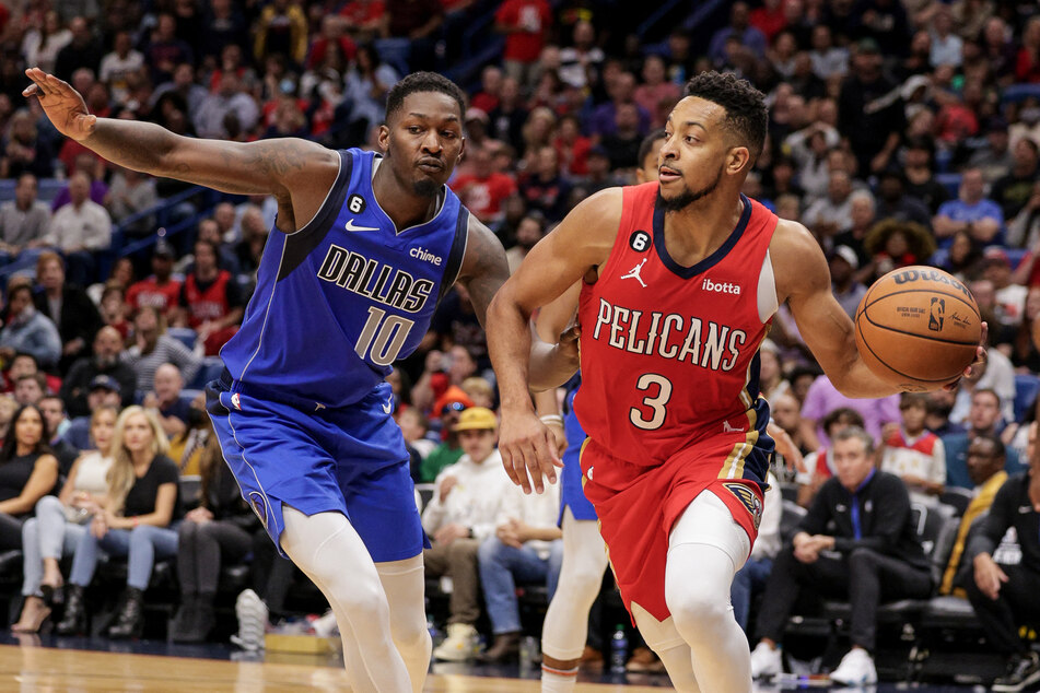 New Orleans Pelicans guard CJ McCollum dribbles against Dallas Mavericks forward Dorian Finney-Smith during the second half at Smoothie King Center.
