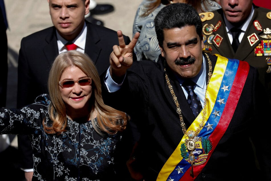 Venezuela's President Nicolas Maduro walks next to his wife Cilia Flores during his arrival for a special session of the National Constituent Assembly to present his annual state of the nation in Caracas on January 14, 2019.